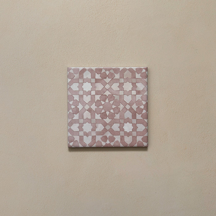 Bedouin Tetuan Rose Moroccan-style 15x15cm single tile featuring an intricate geometric pattern in blush pink and soft white tones, displayed on a warm neutral background to highlight its handcrafted matte finish and subtle texture.