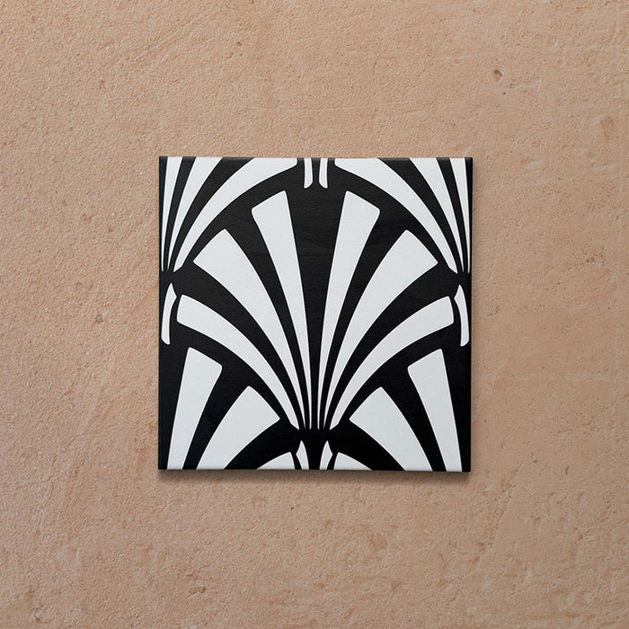 Alhambra Casa 20x20cm Moroccan tile featuring a bold black and white fan-shaped geometric pattern on a terracotta-toned background, perfect for creating elegant Art Deco-inspired interiors.