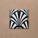 Alhambra Casa 20x20cm Moroccan tile featuring a bold black and white fan-shaped geometric pattern on a terracotta-toned background, perfect for creating elegant Art Deco-inspired interiors.