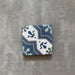 Single Brompton Royal Victorian Pattern 20x20cm tile featuring an intricate geometric and floral design in shades of blue, teal, grey, and white on a textured grey background.