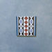 Empire Blue 15x15cm Victorian border tile single piece, showcasing a classic interlocking oval and leaf motif in blue, terracotta, white, and charcoal tones for use with matching patterned floor tiles.