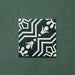 Single Brompton Victorian Green 20x20cm geometric patterned ceramic tile featuring a white floral and star motif on a deep green background, shown against a matching green backdrop in a close-up view.