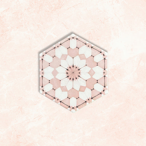 Maroush Dusty Pink 18.7x21.6cm Moroccan hexagonal tile with an intricate floral star design in soft pink and white tones, displayed against a pale marble-effect background.