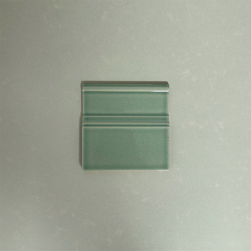 Finchley Lime Green 15 × 15cm ceramic skirting tile with a crackle glaze finish, designed to create a smooth, decorative transition between wall and floor in classic interior spaces.