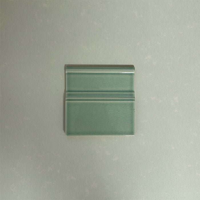 Finchley Lime Green 15 × 15cm ceramic skirting tile with a crackle glaze finish, designed to create a smooth, decorative transition between wall and floor in classic interior spaces.