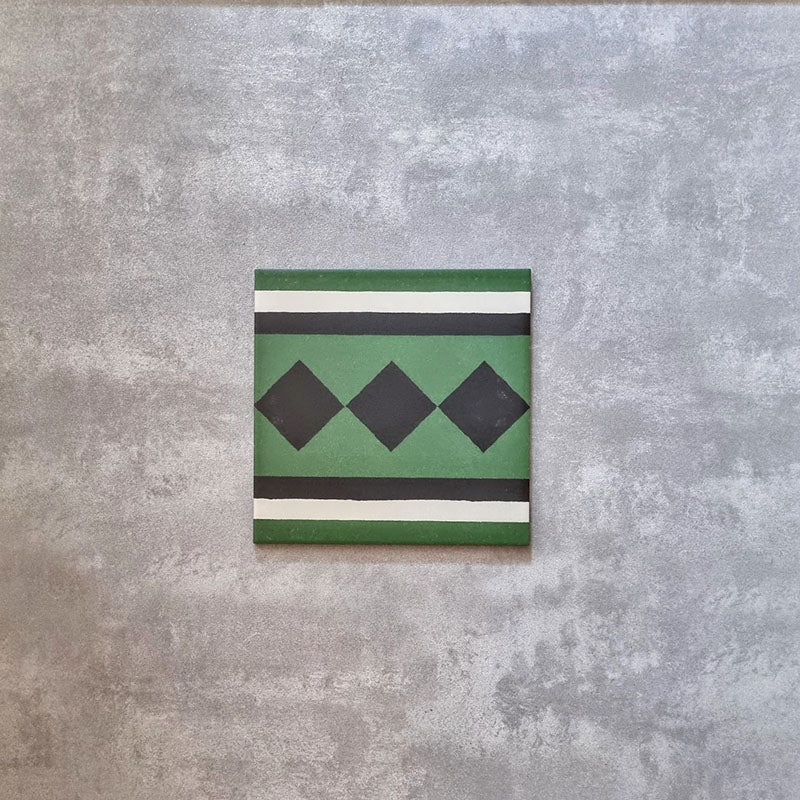 Maison Green Victorian Side/Border 20cm x 20cm, decorative Victorian border tile with geometric diamond motif, deep green, black and white colour palette, matt finish, heritage-style patterned floor tile.