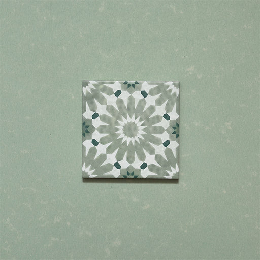 Fizaan Jade Green Mini Moroccan-style 15x15cm porcelain tile featuring a soft green and white geometric star pattern.