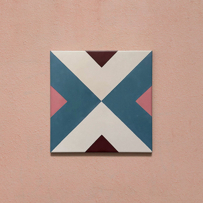 Cabana Guazzatto 20x20cm Moroccan-style porcelain tile featuring a bold geometric cross design in blue, cream, pink, and burgundy shades with a smooth matt finish.