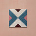 Cabana Guazzatto 20x20cm Moroccan-style porcelain tile featuring a bold geometric cross design in blue, cream, pink, and burgundy shades with a smooth matt finish.