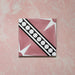 Galata Pink Moroccan Style 20x20cm single tile featuring a diagonal star and geometric border pattern in blush pink, white, and black with a smooth matt finish, shown against a textured pink background.