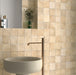 Zellij Arena Square Moroccan Style 10cm x 10cm sink setting, square Moroccan tiles in warm sandy beige and soft cream tones, subtle tonal variation with a lightly textured glazed finish, laid in a neat grid pattern behind a modern basin, creating a warm, handcrafted look ideal for bathroom walls.