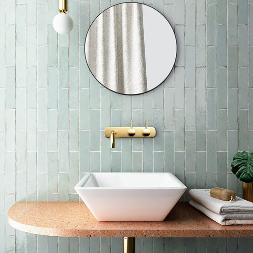 Madison Mint Green Brick Wall Tiles 6x24.6cm — sink setting showcasing the soft, refreshing green tones and subtle gloss finish. Perfectly paired with brass fixtures and natural textures, these tiles bring a calm, contemporary feel to modern bathrooms.