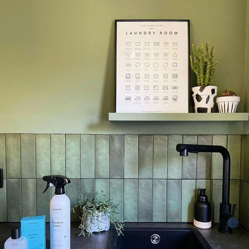 Zellij Malachite Green Brick Moroccan Style 6.5cm x 20cm glazed ceramic wall tiles in rich malachite green tones, vertical brick layout, glossy handcrafted zellige finish with natural tonal variation, sink splashback setting with matte black tapware and soft green interior styling.