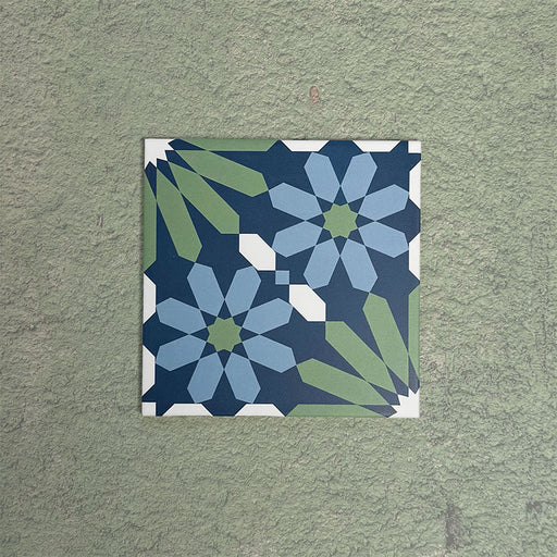 Fizaan Springs Moroccan-style 20×20cm porcelain tile featuring a blue and green geometric star pattern on a decorative surface.