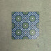 Fizaan Springs Mini Moroccan-style 15×15cm porcelain tiles laid in a repeating geometric pattern, featuring blue and green star motifs.