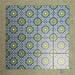 Fizaan Springs Mini Moroccan-style 15×15cm porcelain tiles laid in a repeating geometric pattern, featuring blue and green star motifs.