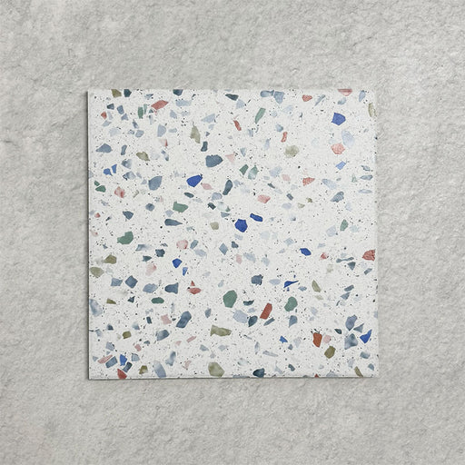 Single Confetti Tutti Frutti 25×25cm terrazzo-style porcelain tile featuring colourful multitone chips on a white base, displayed against a light textured background.