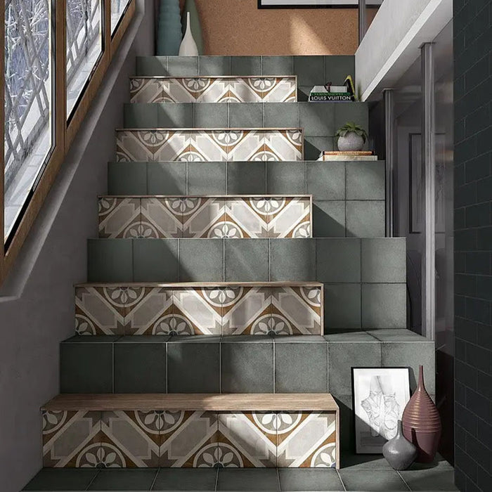 Staircase featuring Carnaby Heythrop Victorian-style 20x20cm porcelain wall and floor tiles used on the stair risers, showcasing a taupe, terracotta, grey, and blue geometric floral pattern, paired with deep green tiles and modern decorative accents.