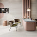 Contemporary interior featuring Storico Travertine Stone matt porcelain wall and floor tiles in a large format, paired with blush pink furnishings, marble surfaces and warm wood accents for a soft, elegant and luxurious design.