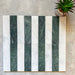 Flat lay of Fitzrovia White 5x20cm honed natural marble brick tiles paired with green marble in a striped layout, showcasing soft white tones, rich green contrast, and natural veining in a linear design.