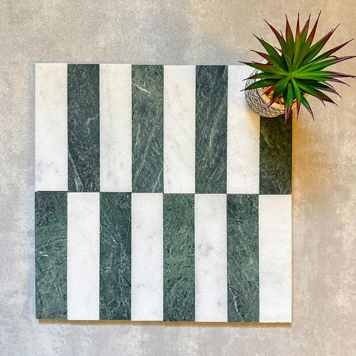 Flat lay of Fitzrovia White 5x20cm honed natural marble brick tiles paired with green marble in an offset striped layout, showcasing soft white tones, rich green contrast, and natural veining in a contemporary linear design.
