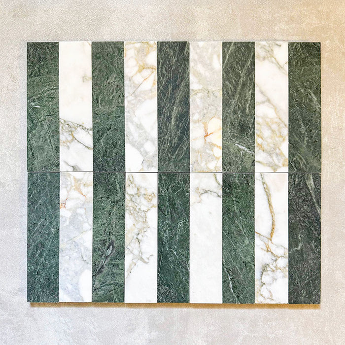 Fitzrovia Calacatta Green 5 x 20cm honed natural marble tiles installed in a vertical striped layout, combining rich green marble with lighter Calacatta tones to create a balanced, design-led pattern that highlights contrast and natural variation.