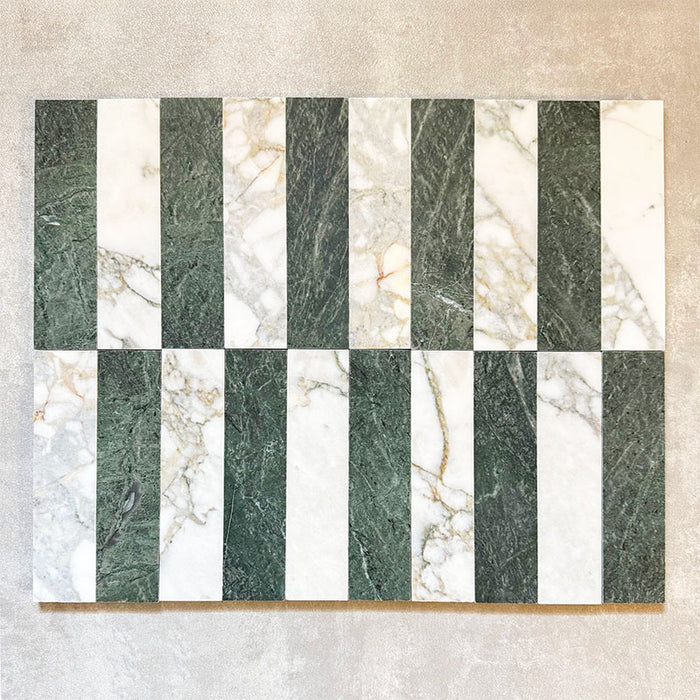 Fitzrovia Calacatta Green 5 x 20cm honed natural marble tiles installed in a vertical striped layout, combining rich green marble with lighter Calacatta tones to create a balanced, design-led pattern that highlights contrast and natural variation.