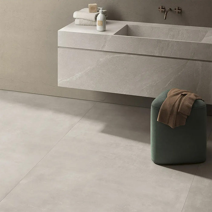 Bathroom interior featuring Tane Stone Pearl Matt 60 × 60cm porcelain floor tiles, styled with a floating vanity, soft neutral tones, and minimal décor for a calm, contemporary finish.