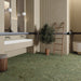 Modern bathroom featuring Terrace Terrazzo Green 60x60cm porcelain tiles on the floor. The soft green terrazzo effect adds natural colour and texture, complemented by warm neutral walls, fluted feature panels, a floating white vanity, timber accents and contemporary lighting for a calm, spa-inspired space.
