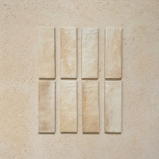 Zellij Arena Brick Moroccan Style 6.5cm x 20cm tiles, slim brick-format tiles in warm sandy beige with soft cream and honey undertones, natural tonal variation, lightly textured glazed finish, Moroccan-inspired handcrafted look.