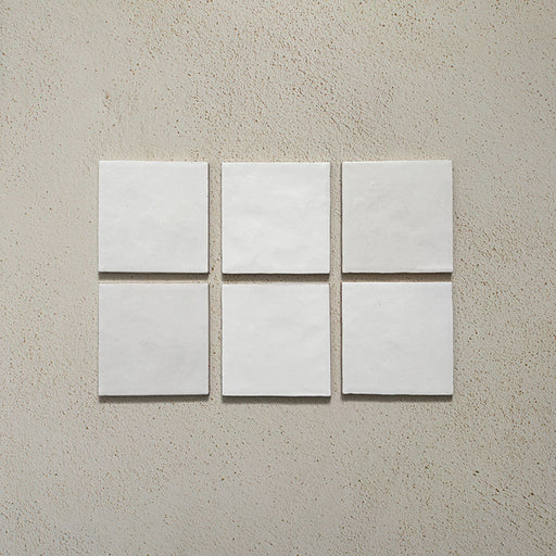Zellij White Gloss Square Moroccan-style tiles in a 13.2cm x 13.2cm format, featuring a glossy white glaze and subtle handmade surface variation, displayed as a flat lay on a neutral background.