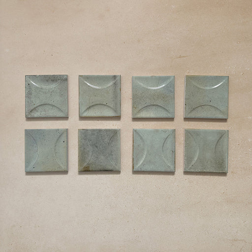 Beijing Celadon Green Decor Square 10x10cm Moroccan-style ceramic wall tiles, styled on a neutral beige background to highlight their raised circular pattern and glossy glaze.