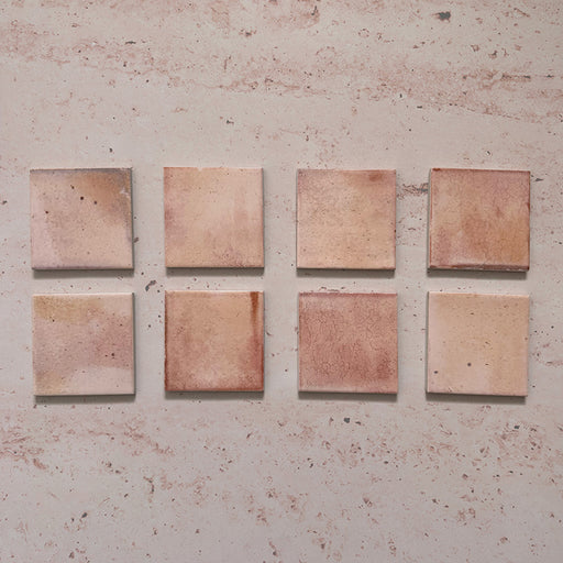 Beijing Rose Pink Square 10x10cm Moroccan-style ceramic wall tiles, styled on a soft pink textured background to highlight their natural glaze variation and handcrafted finish.