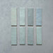 Zellij Aqua Blue brick tiles, 6.5cm x 20cm, Moroccan style, soft aqua blue colour with gentle tonal variation, glossy glazed finish, subtly uneven handcrafted surface, rectangular brick format shown as individual tiles on a neutral background.