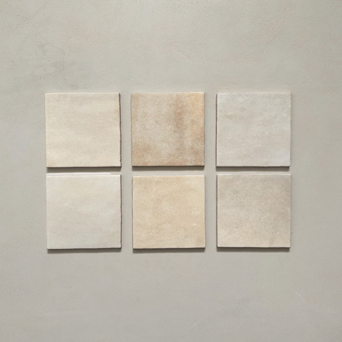 Zellij Bone Square Moroccan-style tiles in a 13.2cm x 13.2cm format, featuring warm beige tones with subtle tonal and handmade surface variation, displayed as a flat lay on a neutral background.