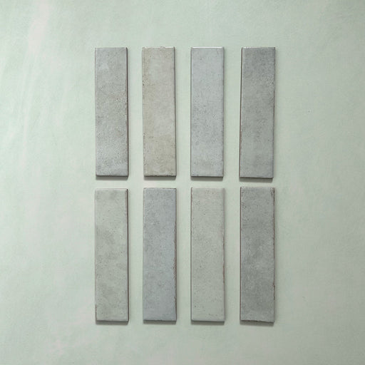 Madison Mint Green Brick Wall Tiles 6x24.6cm — individual tiles displayed to show the soft mint tones and artisanal variation. The subtle colour shifts and glossy finish bring a refreshing, handcrafted feel to kitchens and bathrooms alike.