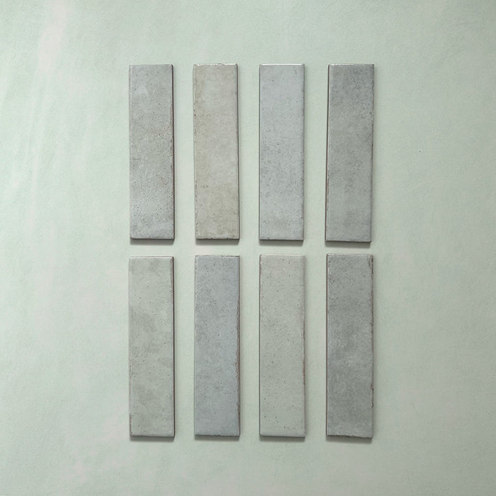 Madison Mint Green Brick Wall Tiles 6x24.6cm — individual tiles displayed to show the soft mint tones and artisanal variation. The subtle colour shifts and glossy finish bring a refreshing, handcrafted feel to kitchens and bathrooms alike.