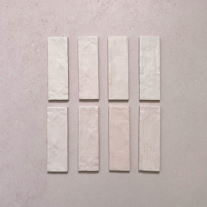 Zellij Pink Mist brick tiles, 6.5cm x 20cm, rectangular format, soft blush pink tones with gentle tonal variation, glossy glazed finish, Moroccan-inspired handcrafted style.