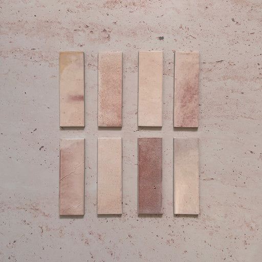 Beijing Rose Pink Brick 5.1x16.1cm Moroccan-style ceramic wall tiles, styled on a soft pink textured background to highlight their natural tonal variation and glossy handcrafted finish.