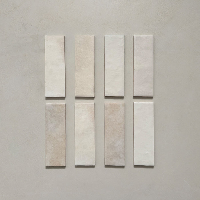 Zellij Bone Brick Moroccan-style tiles in a 6.5cm x 20cm brick format, featuring a soft warm beige tone with subtle tonal variation and handmade surface texture, displayed as a flat lay on a neutral background.