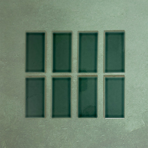 Flat lay of Finchley Golders Green 7.5 × 15cm ceramic tiles with a crackle glaze finish, highlighting deep green tones, subtle surface texture and tonal variation for elegant wall tile designs.