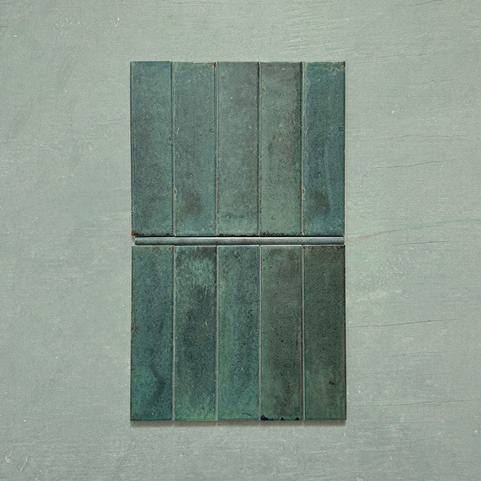Izmir Green Gloss Pencil Bullnose Border Tile 1.2x30cm shown with matching Izmir Brick Green Gloss 6x25cm tiles, highlighting the glossy handcrafted effect finish and smooth rounded edge detail.