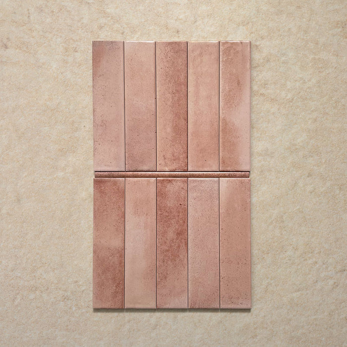 Izmir Tusk Rose Gloss Pencil Bullnose Border Tile 1.2x30cm — shown with matching Tusk Rose brick tiles. The soft pink tones and handcrafted gloss finish create a warm, artisan feel, while the pencil bullnose border adds a refined edge — ideal for framing splashbacks, feature walls, and alcoves with a polished finish.