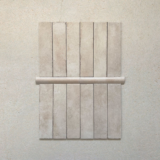 Madison Oatmeal Bullnose Pencil Border Tiles 3x20cm — shown paired with matching Madison Oatmeal brick tiles. This elegant border piece offers a smooth curved edge that adds a refined finish to walls, niches, and splashbacks, completing any design with subtle sophistication.