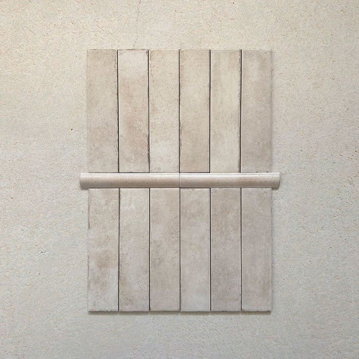Madison Oatmeal Bullnose Pencil Border Tiles 3x20cm — shown paired with matching Madison Oatmeal brick tiles. This elegant border piece offers a smooth curved edge that adds a refined finish to walls, niches, and splashbacks, completing any design with subtle sophistication.