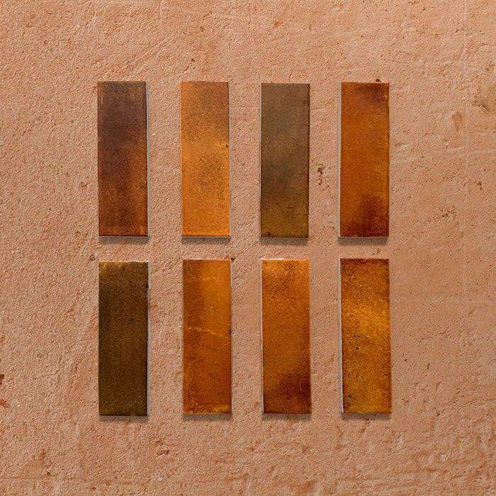 Beijing Amber Brick 5.1x16.1cm Moroccan-style ceramic wall tiles, styled on a warm textured background to highlight their rich glaze and handcrafted finish.