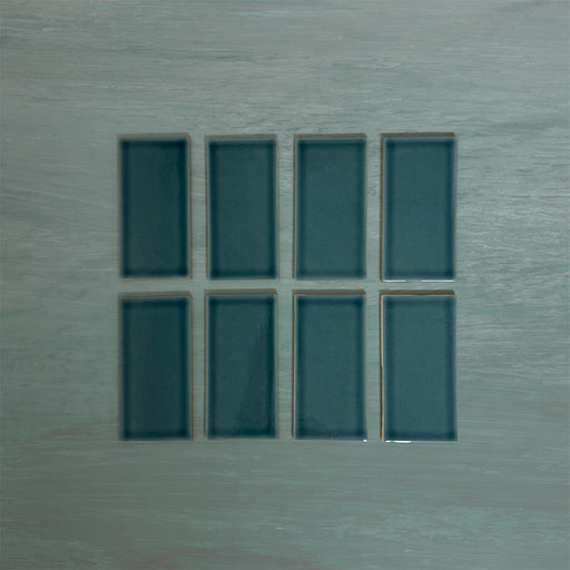 Flat lay of Finchley River Blue 7.5 × 15cm ceramic tiles with a crackle glaze finish, highlighting rich blue tones, subtle surface texture and tonal variation for elegant wall tile designs.