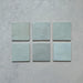 Zellij Aqua Blue Square Moroccan Style tiles, 13.2cm x 13.2cm, square format, soft aqua blue colour with subtle tonal variation, glossy glazed finish, handcrafted Moroccan-inspired design shown as individual tiles.
