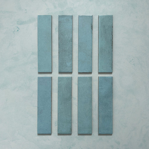 Madison Aquamarine Brick Wall Tiles 6x24.6cm — individual tile layout showcasing the rich teal tones and subtle surface variations. Each glossy brick-style tile reflects light beautifully, adding depth and a handcrafted charm perfect for modern kitchens, bathrooms, or feature walls.