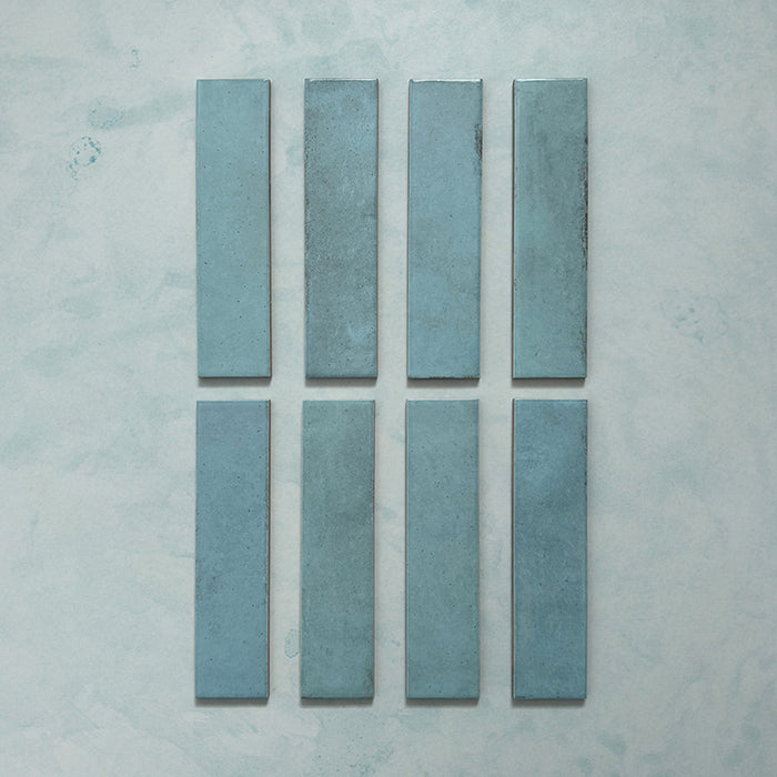 Madison Aquamarine Brick Wall Tiles 6x24.6cm — individual tile layout showcasing the rich teal tones and subtle surface variations. Each glossy brick-style tile reflects light beautifully, adding depth and a handcrafted charm perfect for modern kitchens, bathrooms, or feature walls.